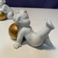 putti on ball with leg up
